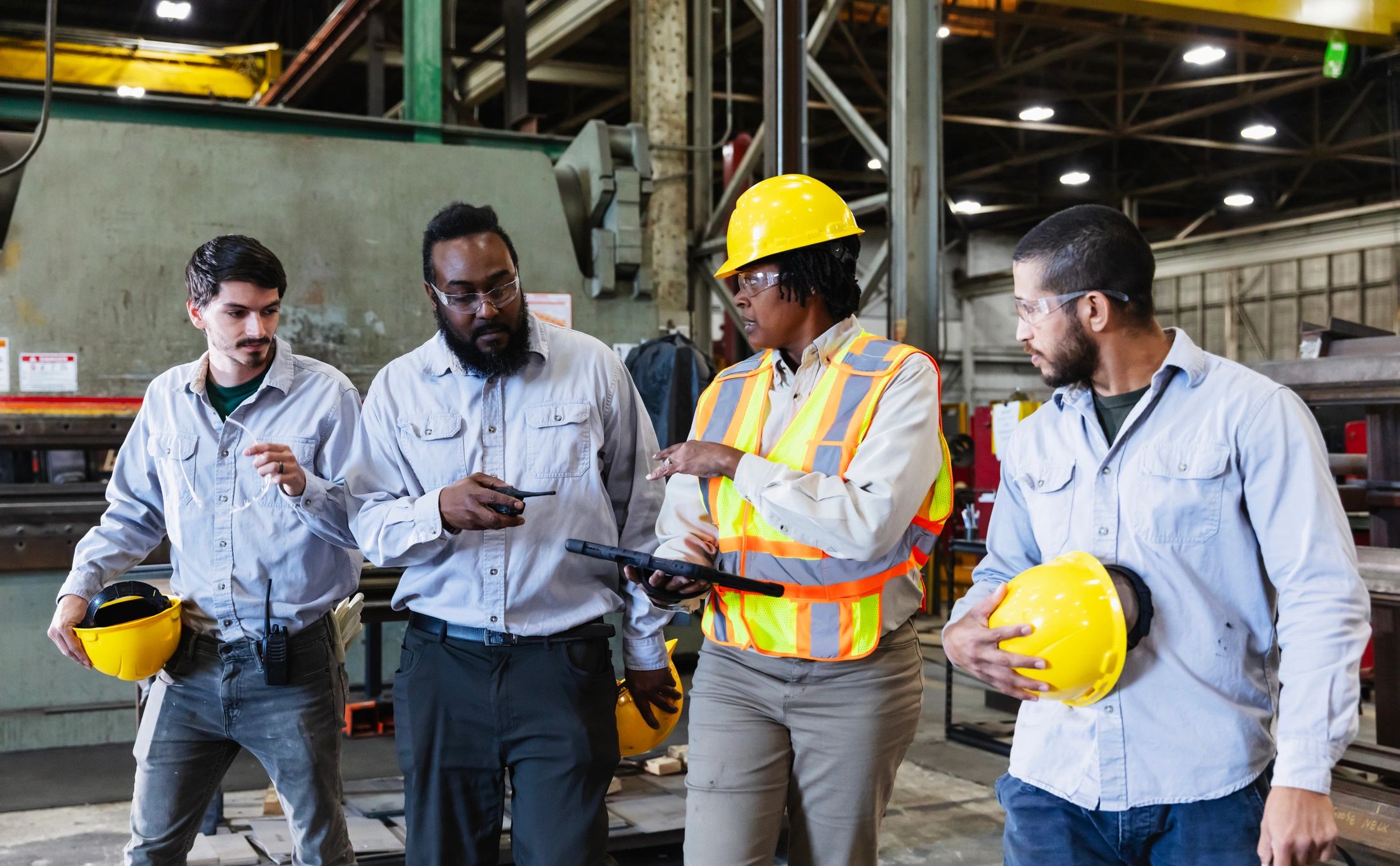 Maintenance team reviewing work on a factory floor